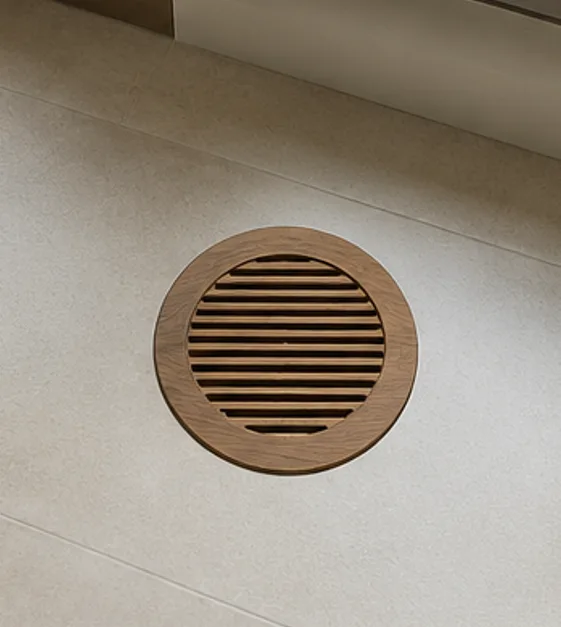 Round-face slotted wooden vent register with circular cut-out in square frame