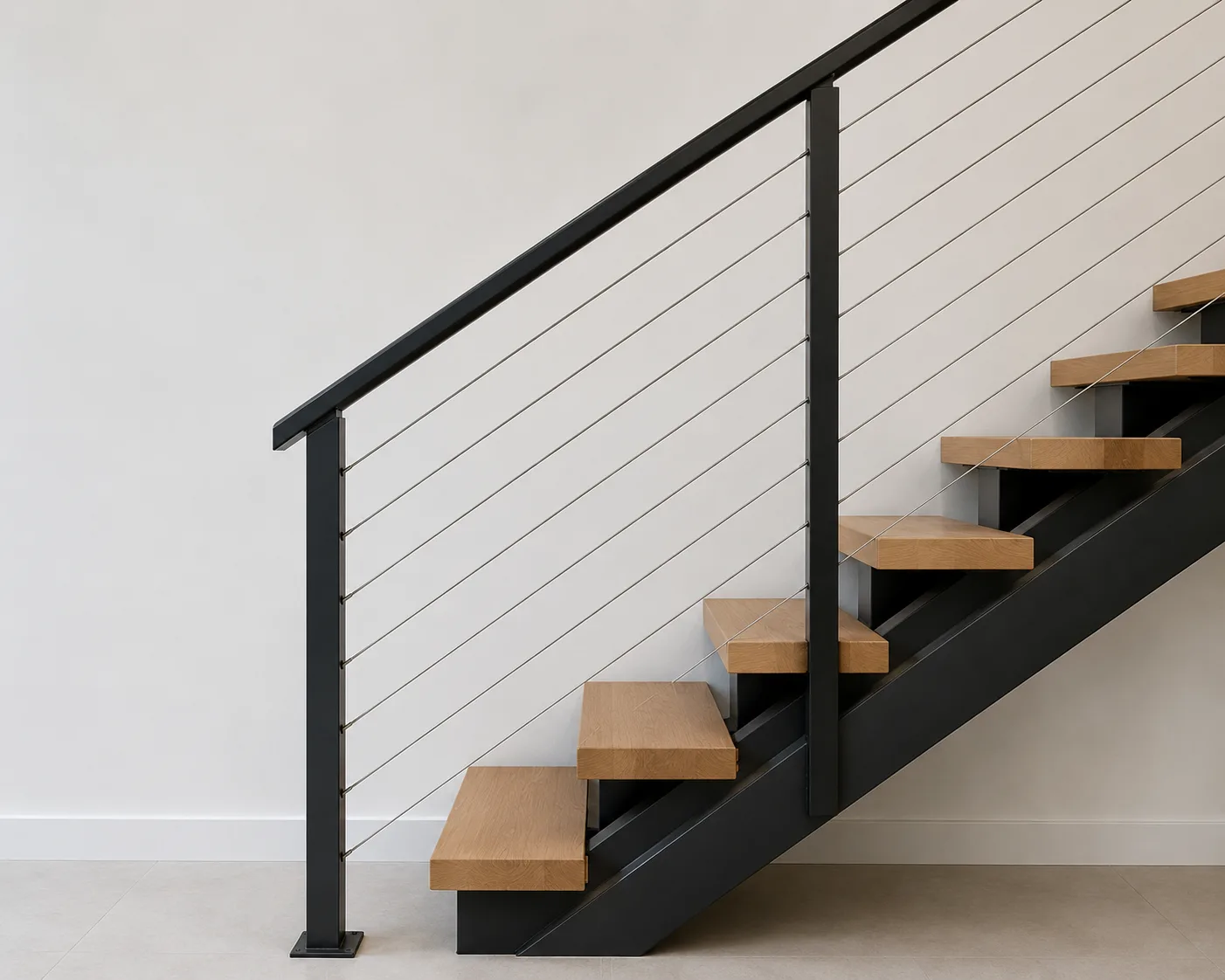 Stainless steel cable handrail system on metal stringer staircase